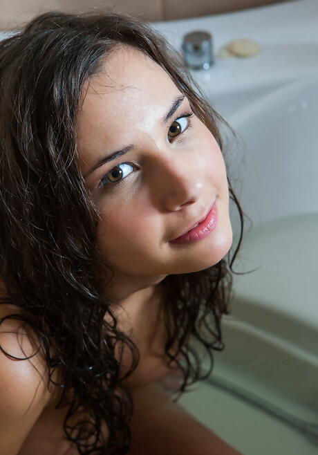 Sylphlike brunette teen Oretha Mars exhibiting her ass and shaved pussy in bathroom